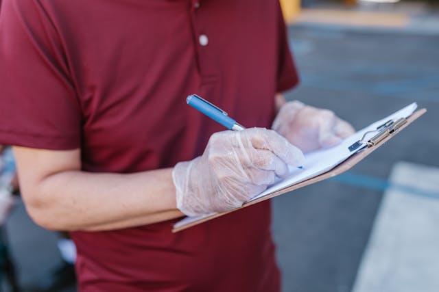 Landlord writing on a clipboard